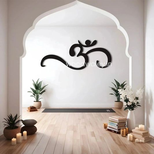 Minimalist home decor with large Om wooden wall art, potted plants, candles, and yoga mat