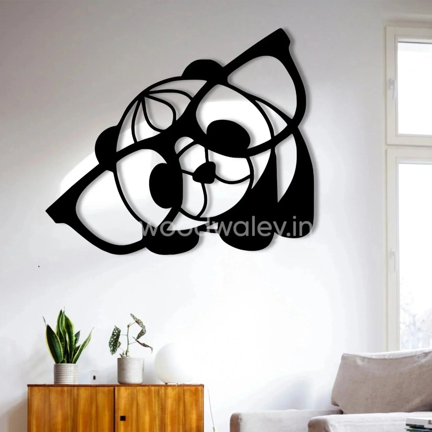 Modern black wooden dog wall art decor in living room with plants and natural light
