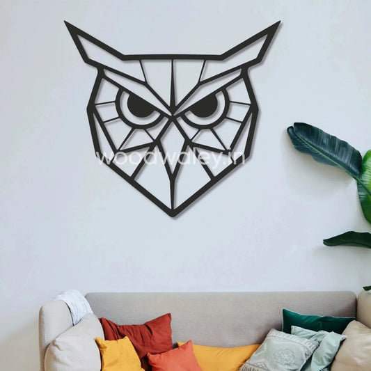 Geometric wooden owl wall art decor above modern sofa with colorful cushions and green plant