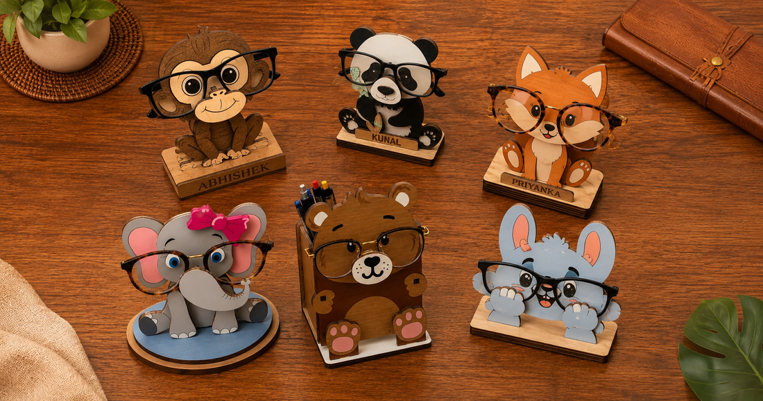 Woodwaley Zoo Buddies collection — multiple carved wooden animal eyeglass stands displayed together on a warm teak surface, each holding a pair of glasses