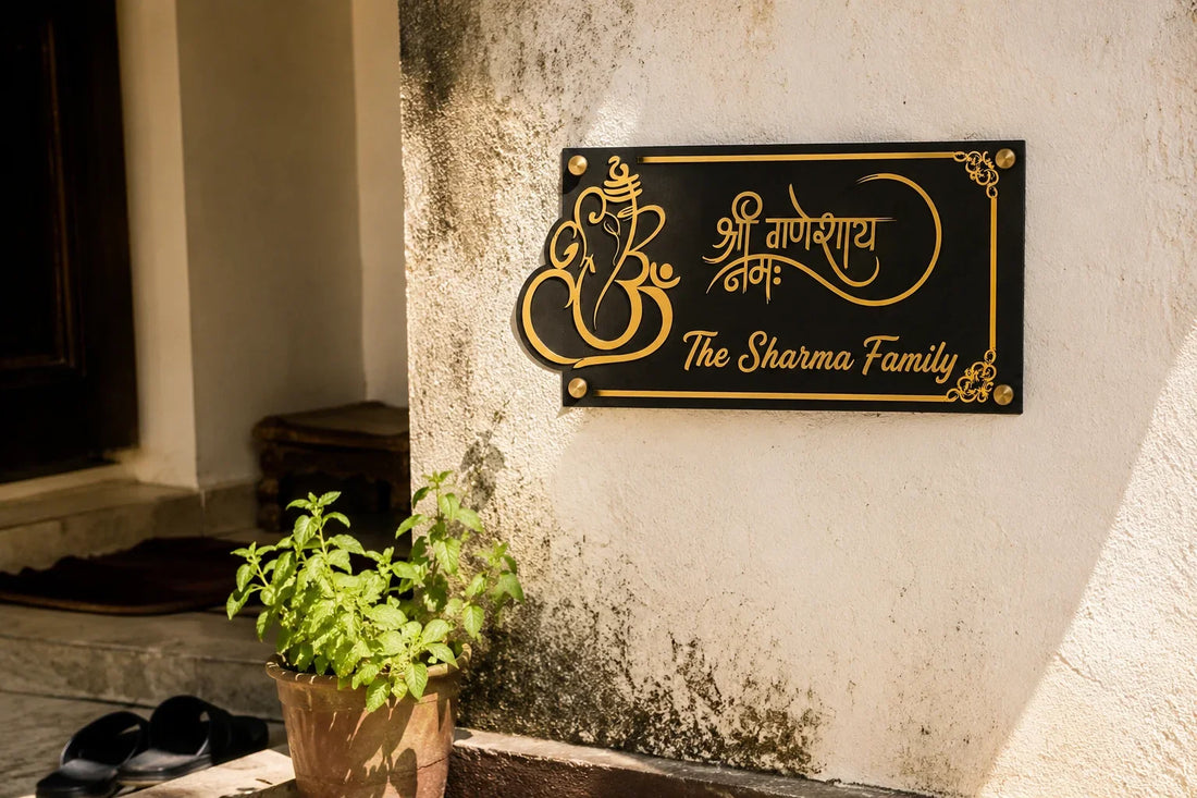 Ganesha acrylic name plate mounted on an Indian home entrance wall facing East in morning sunlight