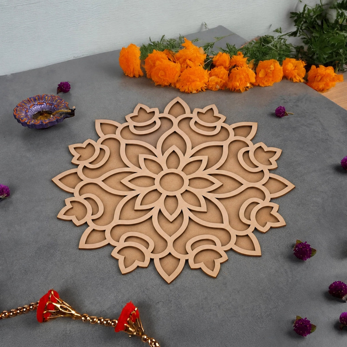 Padma Mandala Art Wooden Rangoli - styled flatlay with marigolds and rakhi