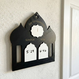 Decorative wall hanging with clock and time markers on a white wall