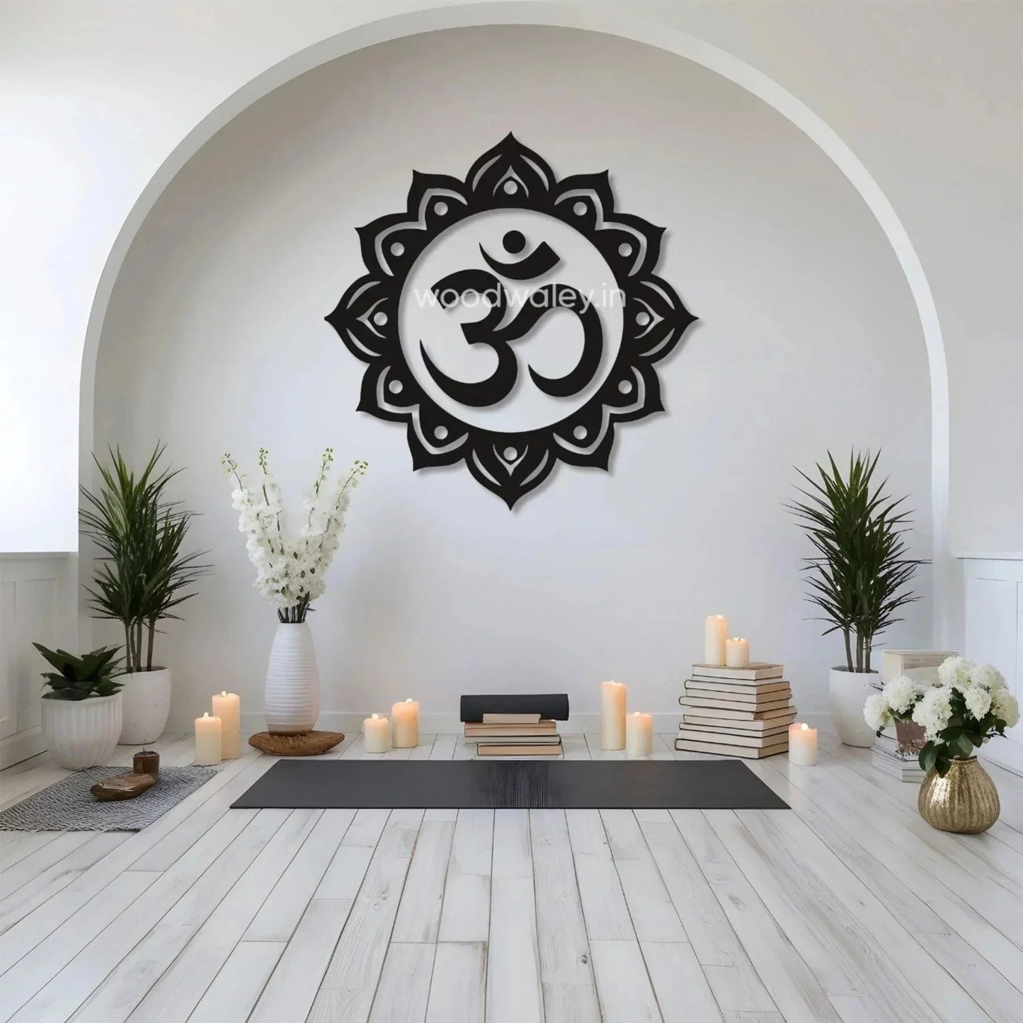 Handcrafted wooden Om wall art in a modern yoga room with candles, plants, and books