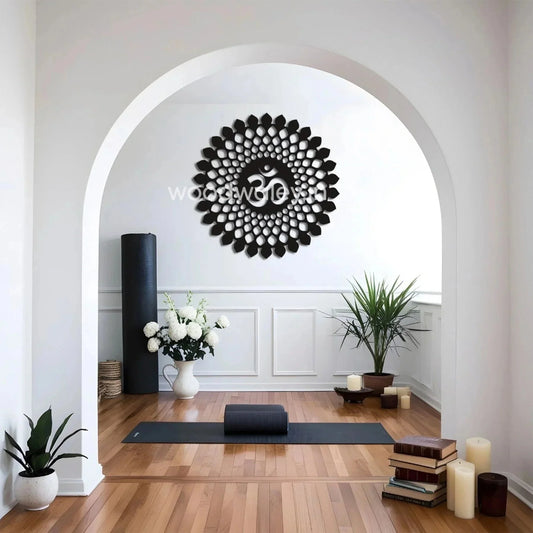 Decorative wooden Om wall art in a serene yoga room with plants and candles