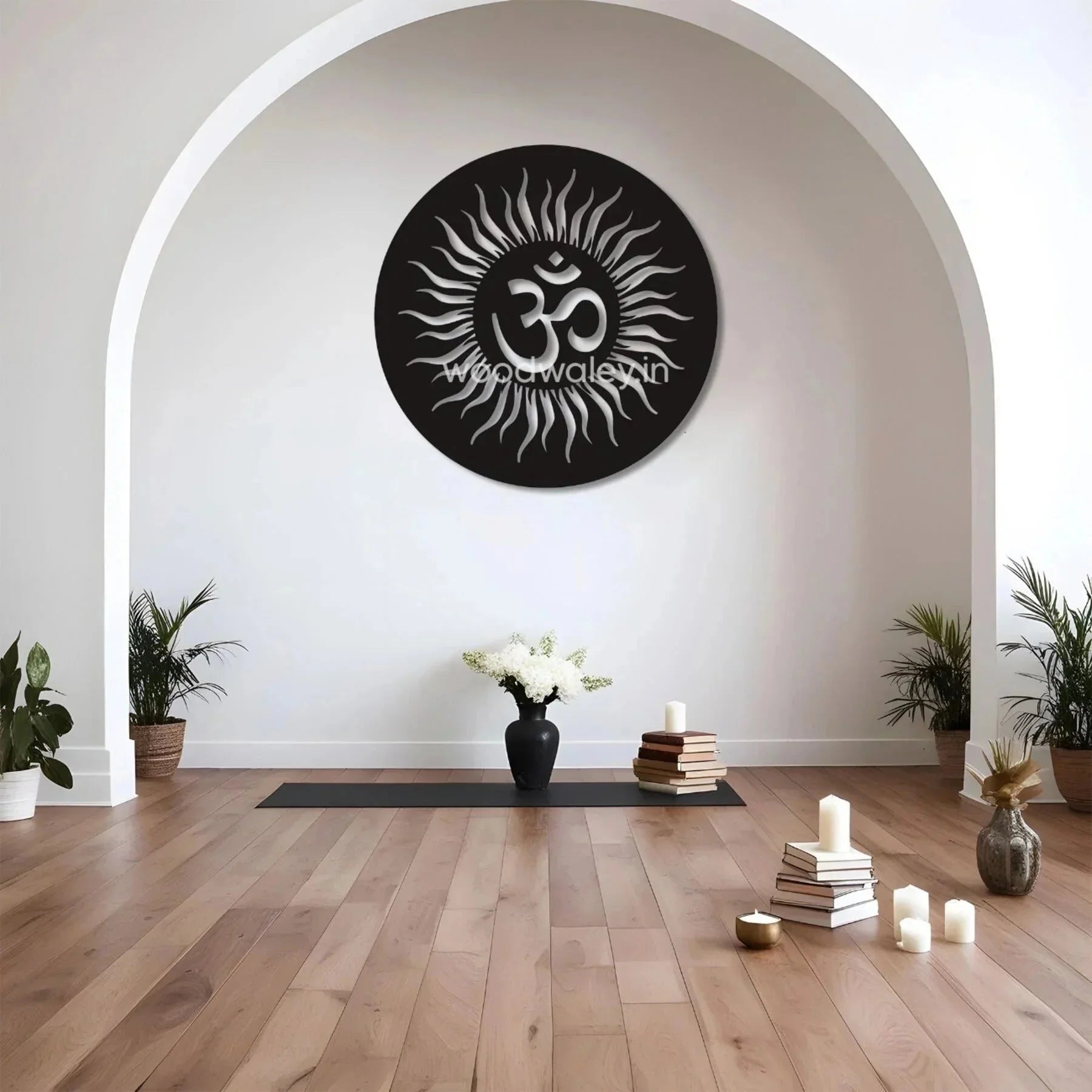 Handcrafted wooden Om wall decor with sun design in a minimalist living room, yoga mat, candles, plants, and books.