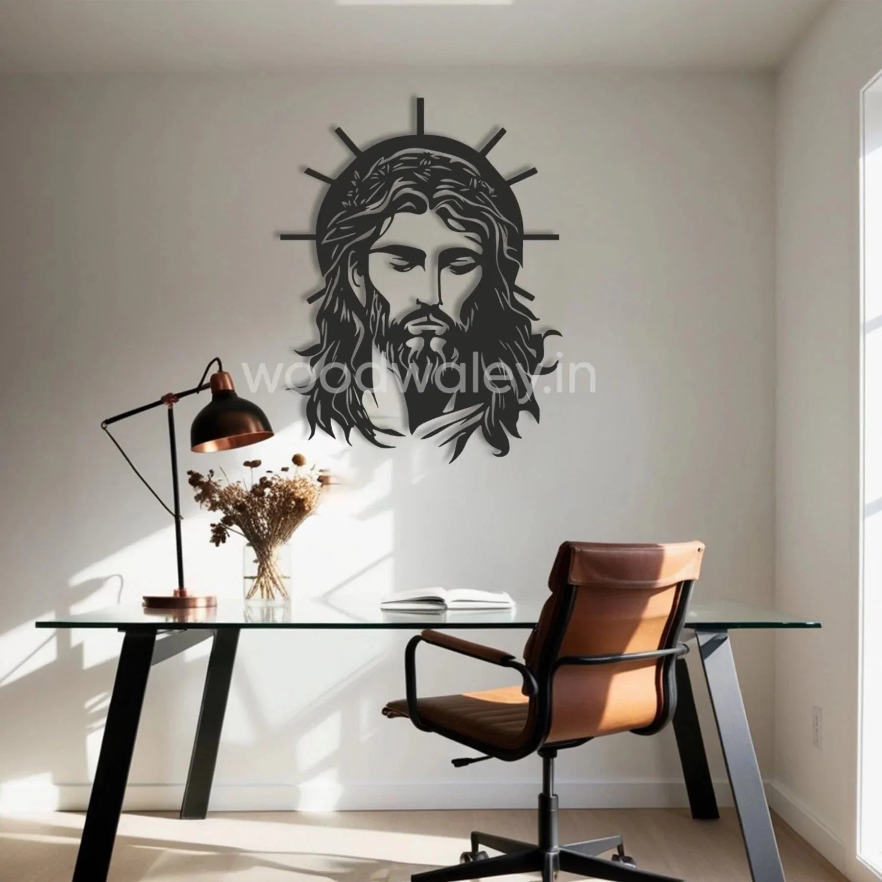 Handcrafted wooden wall art of Jesus with halo in a modern home office with glass desk