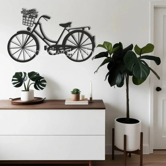 Modern living room with a black bicycle wall art, white sideboard, and potted plants decor.